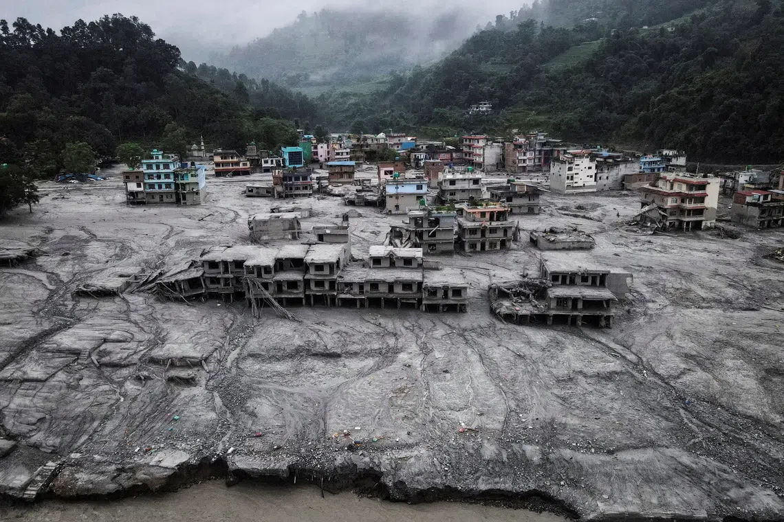A drone view shows houses covered in mud after the flash floods and mudslide, at Devighat, Nuwakot district, Nepal, August 29, 2026.