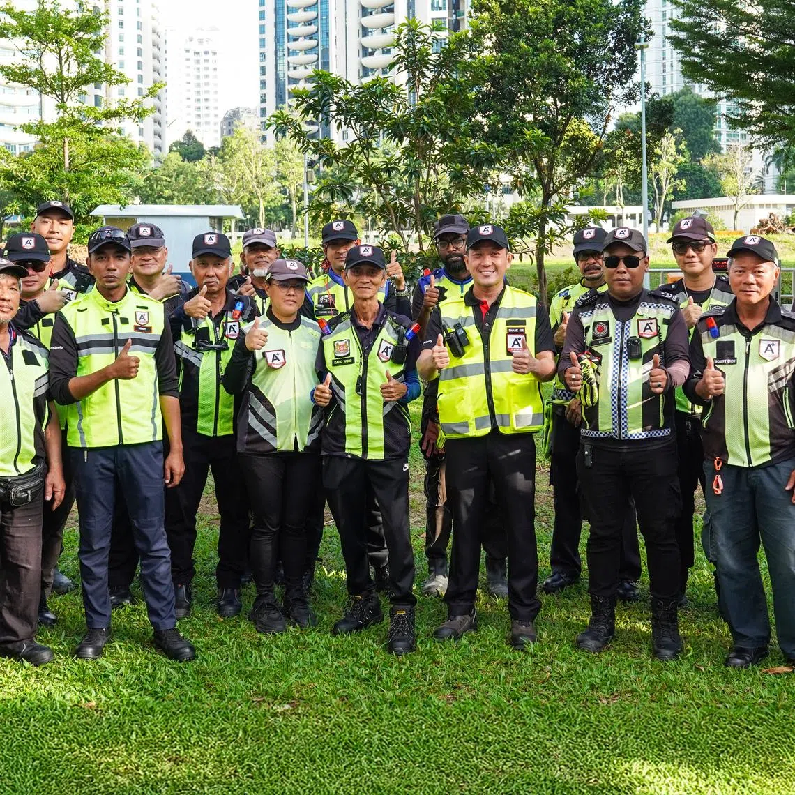 Mr Shane Shi (first row, fourth from right), managing director at A+ Officers Security, with members of his team. The company deploys 150 traffic marshals daily and has a client base of over 30 contractors that use their services regularly. 