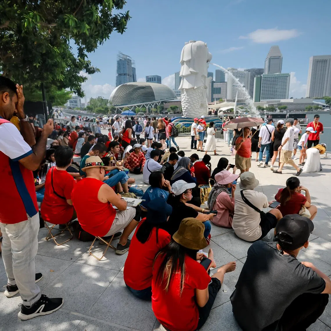 The public reserving their spots at Merlion Park for the National Day Parade fireworks at about 3pm, Aug 9, 2023.