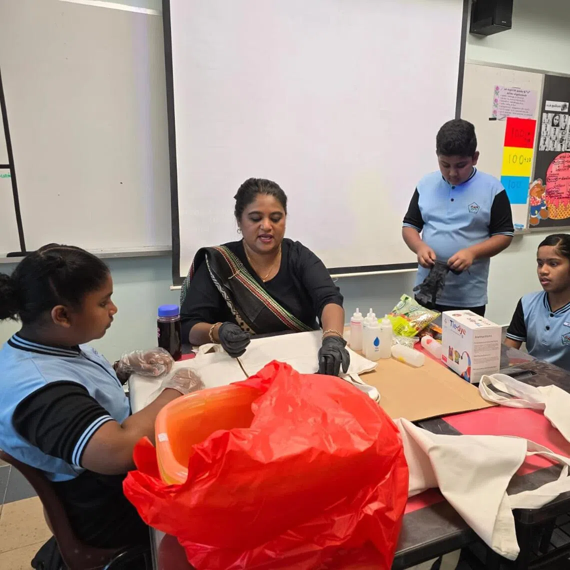 Mdm Normanisha teaching her students Bhandani, an ancient Indian tie-and-dye art form that uses tiny knots to create intricate patterns, during one of her Tamil classes.