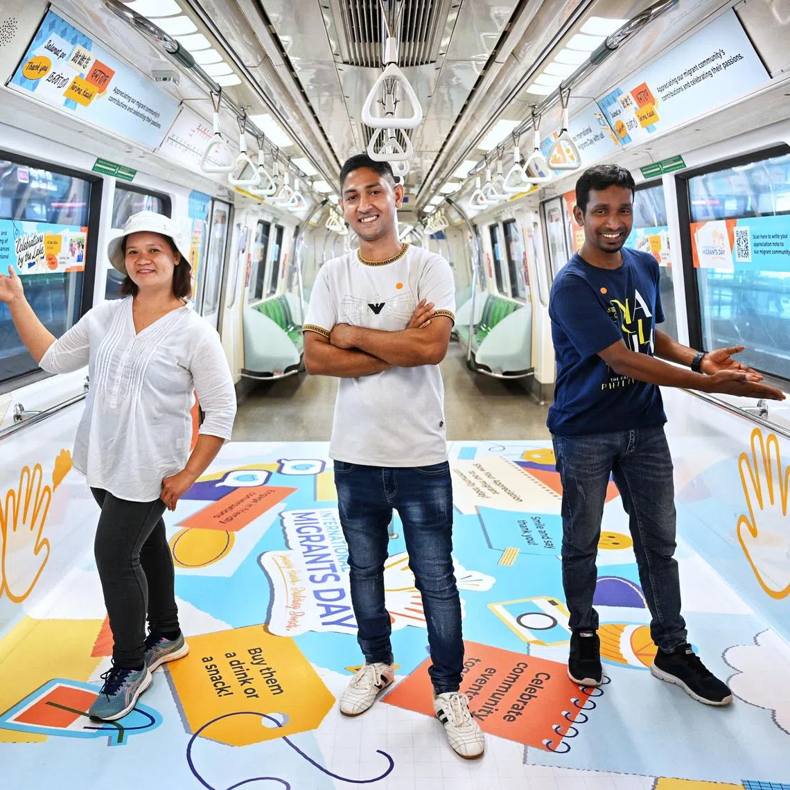 (From left) Migrant workers Quijano Ruby Ledesma, Mohammead Ashik Hossen and Basir Uddin at the launch of concept train at Ang Mo Kio MRT station on Dec 9.