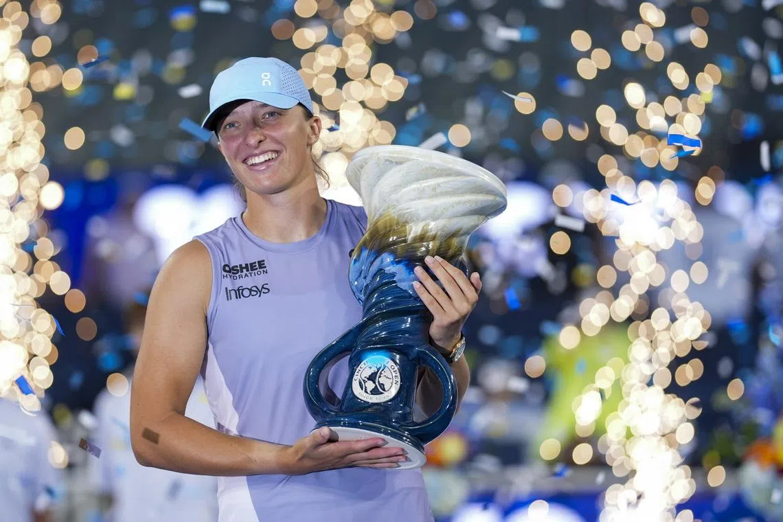 Aug 18, 2025; Cincinnati, OH, USA;  Iga Swiatek (POL) poses for a photo with the Rookwood Cup after defeating Jasmine Paolini (ITA) during the Cincinnati Open at the Lindner Family Tennis Center. Mandatory Credit: Aaron Doster-Imagn Images