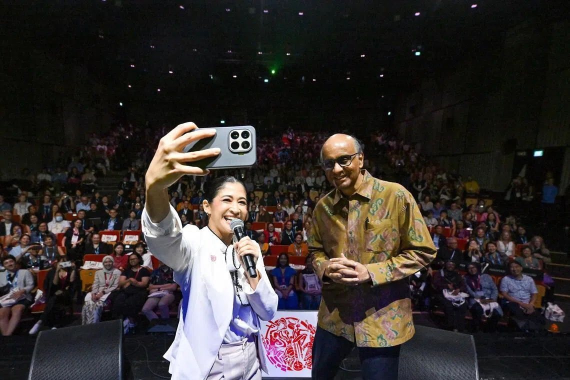 President Tharman Shanmugaratnam on stage at the International Society for the Performing Arts (ISPA) congress at the Singtel Waterfront Theatre. With him is emcee Munah Bhagarib. 