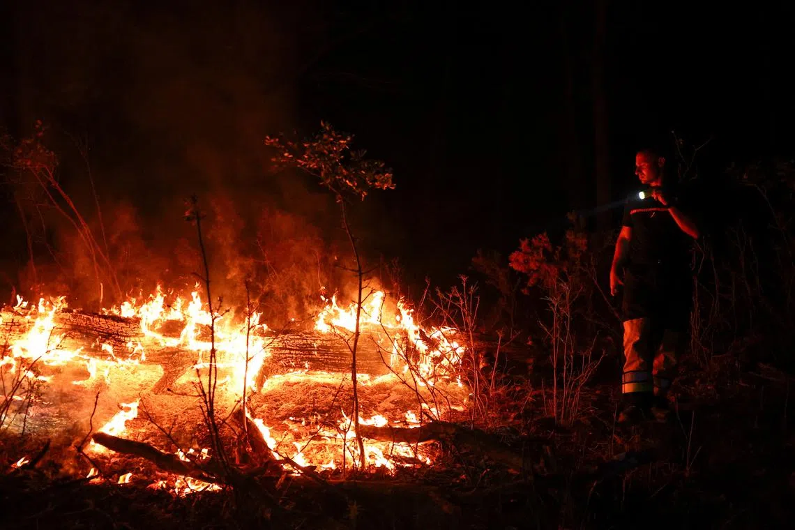 France’s biggest wildfire in nearly eight decades has caused 18 people – including 16 firefighters – to be injured, and killed a woman whom officials said had disregarded evacuation orders. 