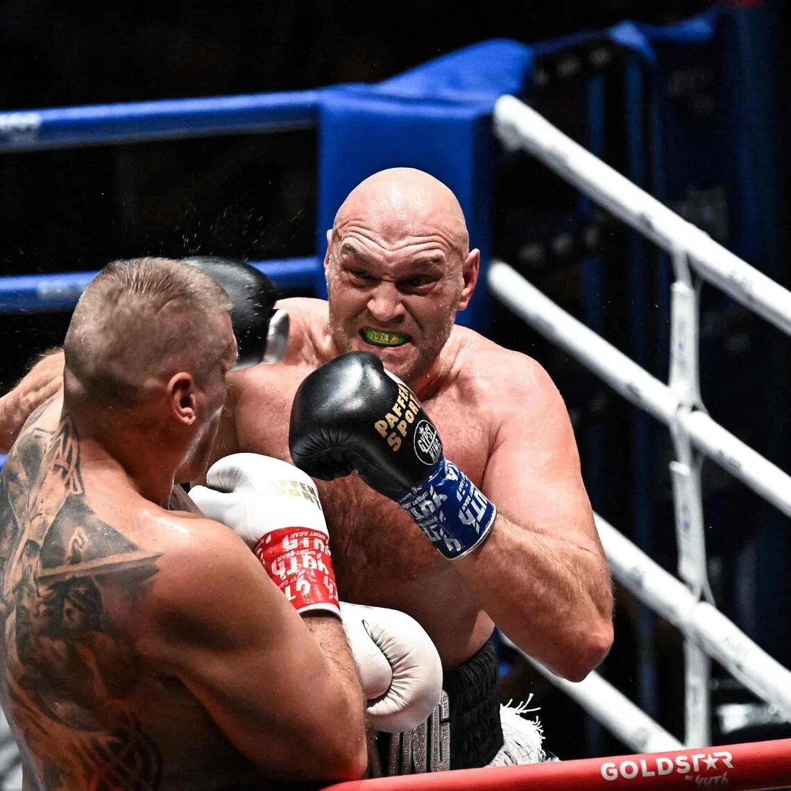 Britain’s Tyson Fury (right) trading blows with Poland’s Mariusz Wach during a charity boxing bout in Pattaya on July 24.