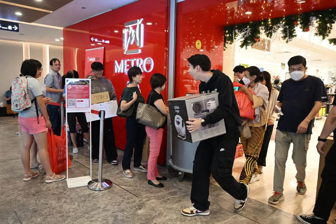 Shoppers leaving the Metro department store in Paragon to queue up for home delivery service during Black Friday on Nov 24.