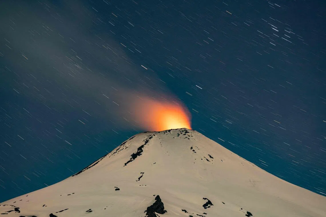 The Villarrica volcano shows signs of activity, as seen from Pucon, some 800 kilometers south of Santiago, on December 1, 2022. - Villarrica volcano is among the most active in South America.