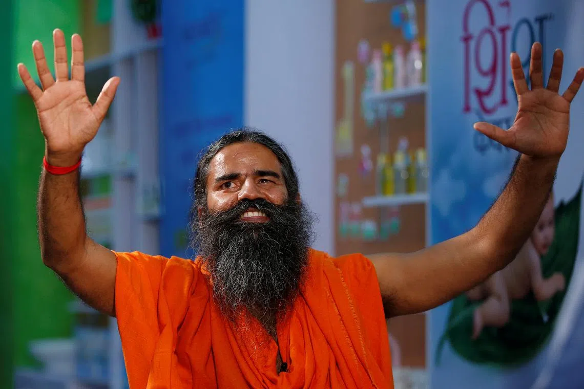 FILE PHOTO: Indian yoga guru Baba Ramdev gestures as talks to media after a news conference in New Delhi, India, May 4, 2017. To match Special Report INDIA-MODI/RAMDEV REUTERS/Adnan Abidi/File Photo