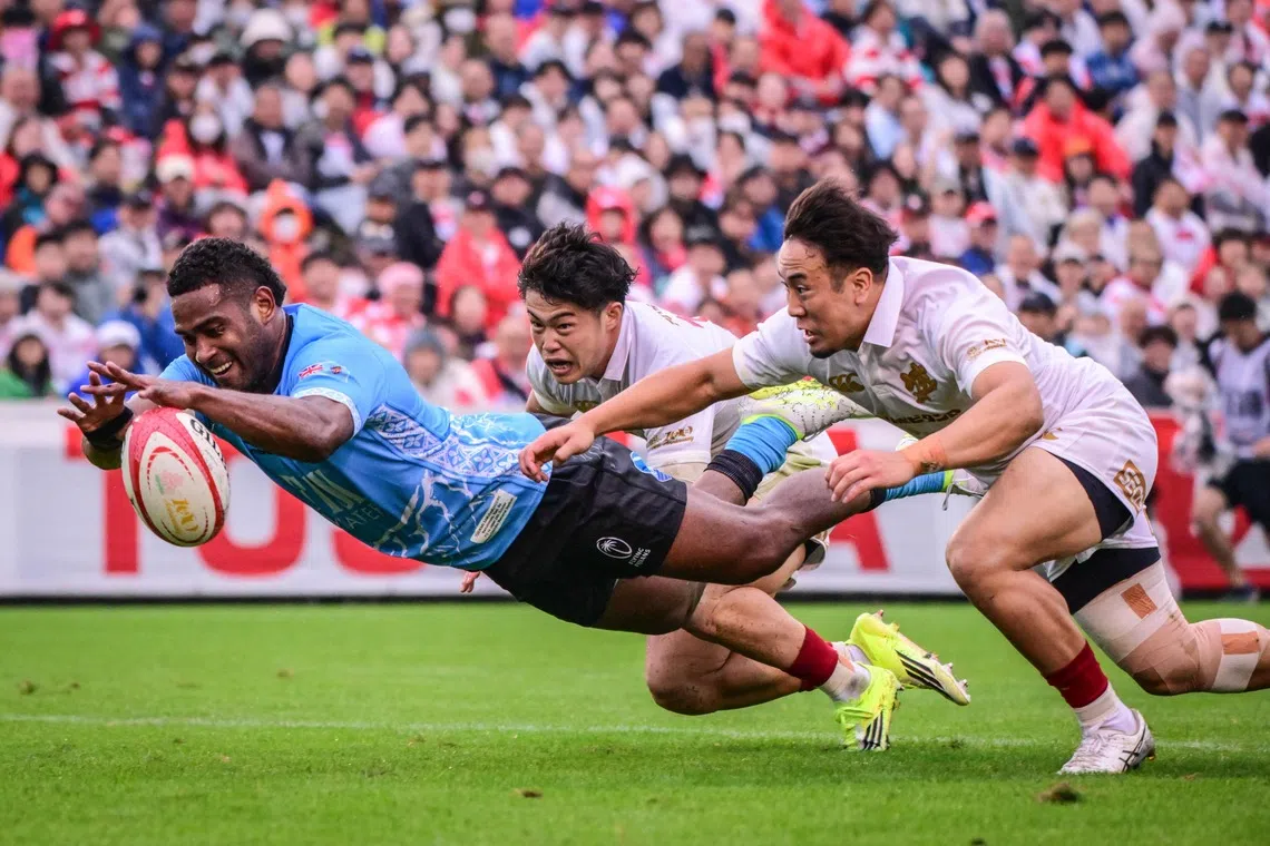 Fiji’s Tuidraki Samusamuvodre scores a try during an international test match between Japan and Fiji at the Prince Chichibu Memorial Rugby Ground in Tokyo on Oct 24.