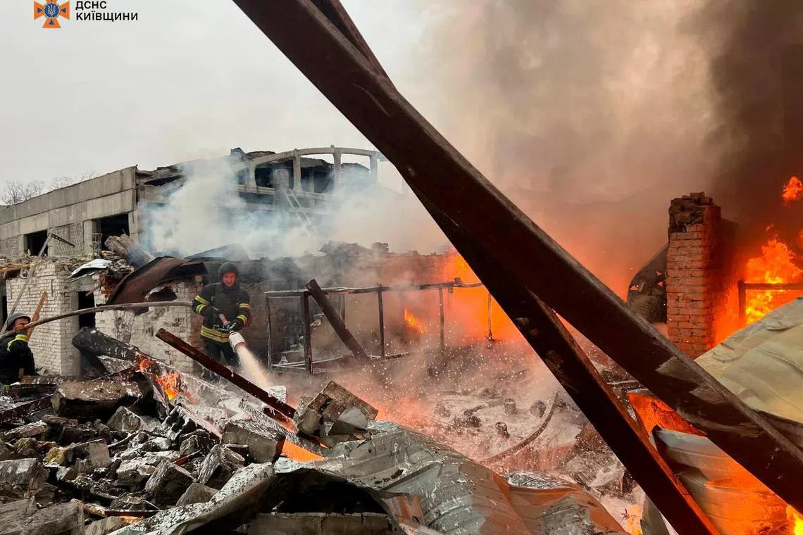 Firefighters working at a site where an industrial area was hit by a Russian missile strike in the Kyiv region on  Nov 13.  