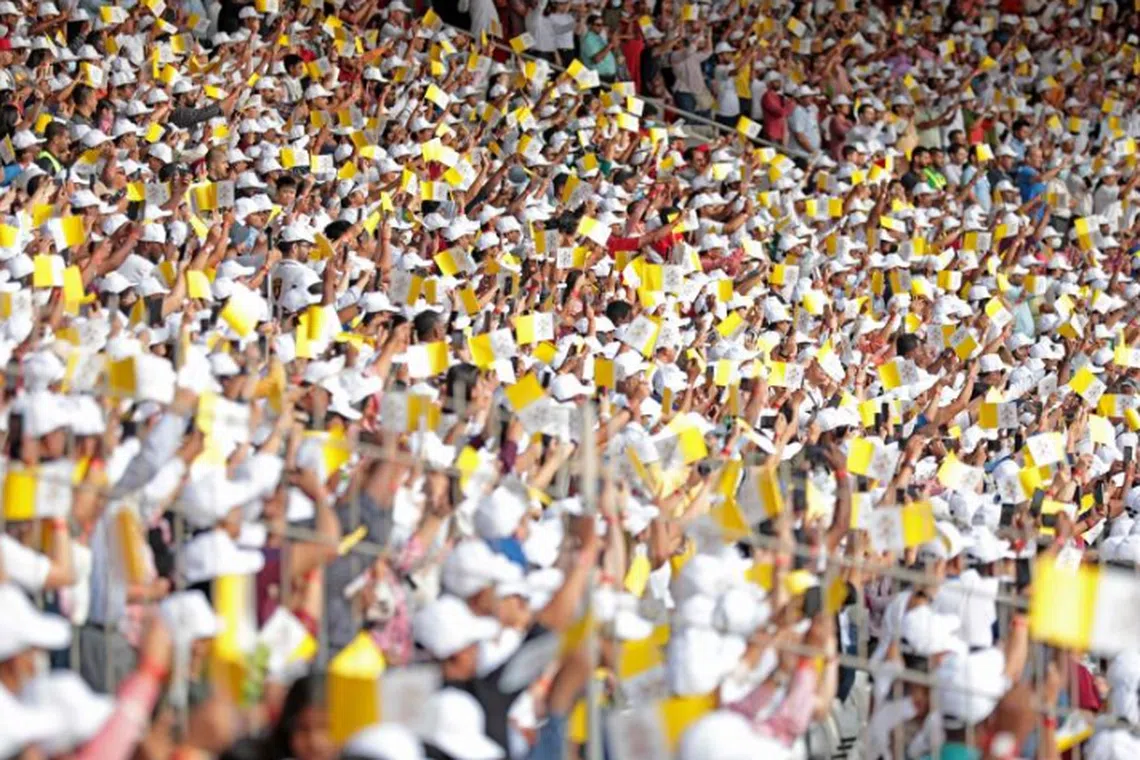 Worshippers attend a mass held by Pope Francis at Bahrain National Stadium on Nov 5, 2022. About 30,000 flag-waving worshippers were present.