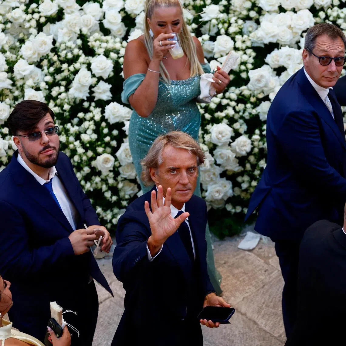 Former Italy coach Roberto Mancini waves toward photographers following the wedding ceremony of Manchester City and Italy goalkeeper Gianluigi Donnarumma and Alessia Elefante at the Chiesa Madre di San Giorgio Martire in Locorotondo, southern Italy, on July 24, 2026.