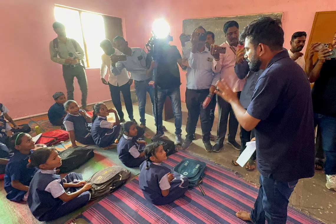 Founder of the Cockroach Janta Party Abhijeet Dipke (right) visiting a government school in the Hingoli district, where the principal was suspended for drinking in school.