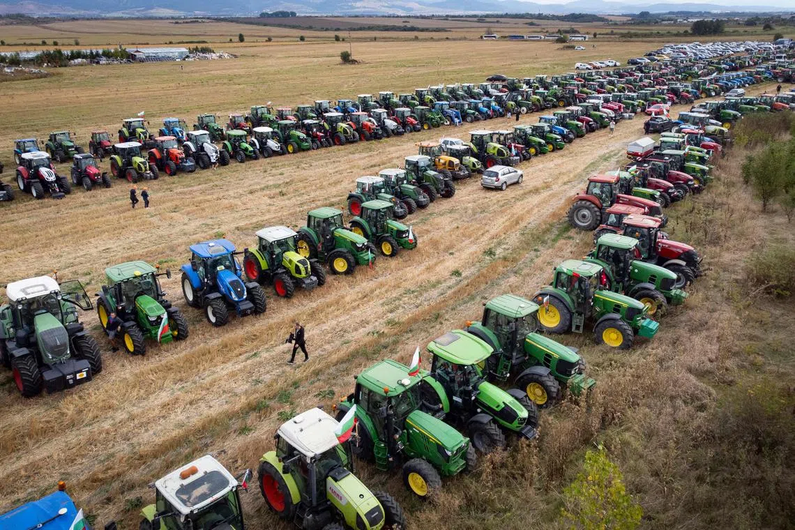 Tractors parked in a field during a protest against the lifting of ban on imports of grain coming from Ukraine, in Dolni Bogrov, near Sofia in Bulgaria on Sept 19.