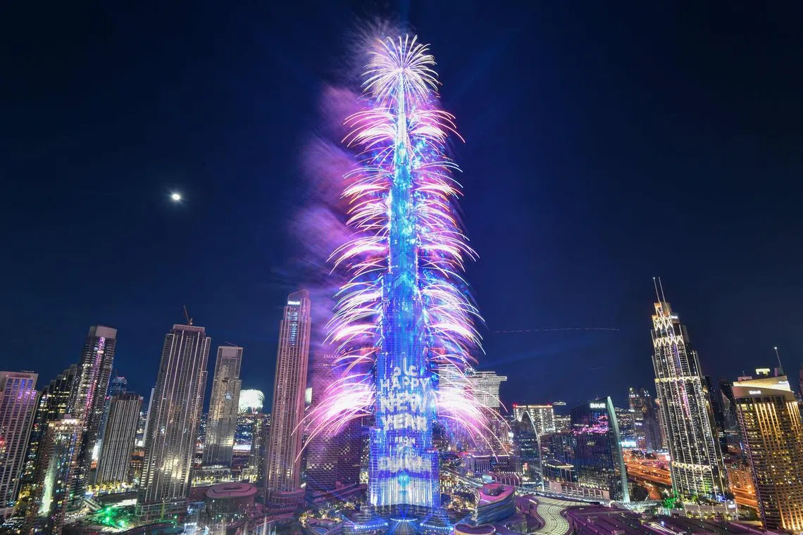 New Year's Eve fireworks light the landmark Burj Khalifa tower at midnight in the Gulf emirate of Dubai on Dec 31, 2022. 