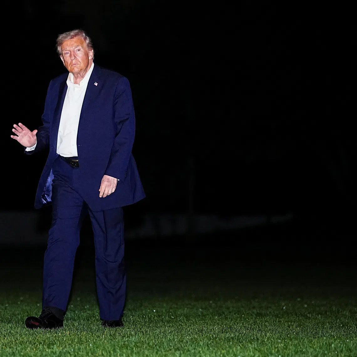 U.S. President Donald Trump waves while walking on the South Lawn as he arrives back at the White House, after participating in a world leaders' summit in Egypt on ending the Gaza war, amid a ceasefire between Israel and Hamas in Gaza, in Washington, D.C., U.S., October 14, 2025. REUTERS/Aaron Schwartz
