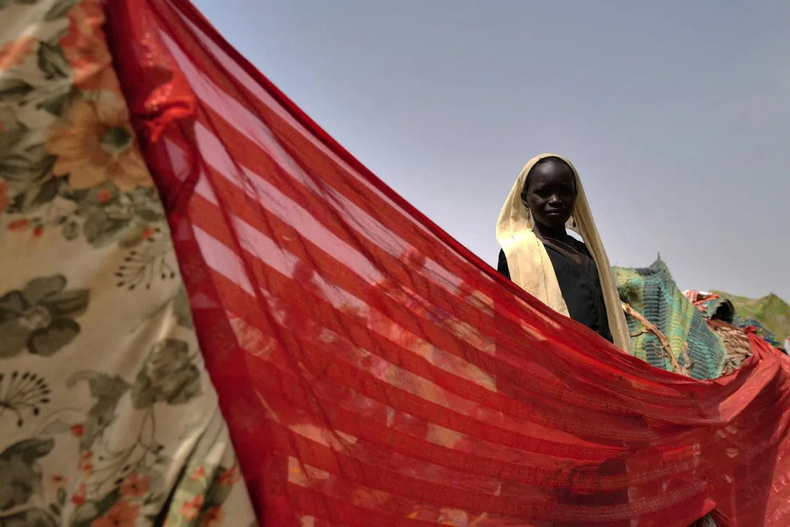 A sudanese girl who fled the conflict in Sudan's Darfur region, and was previously internally displaced in Sudan, standing at her makeshift shelter near the border between Sudan and Chad, while taking refuge in Borota, Chad on May 13.