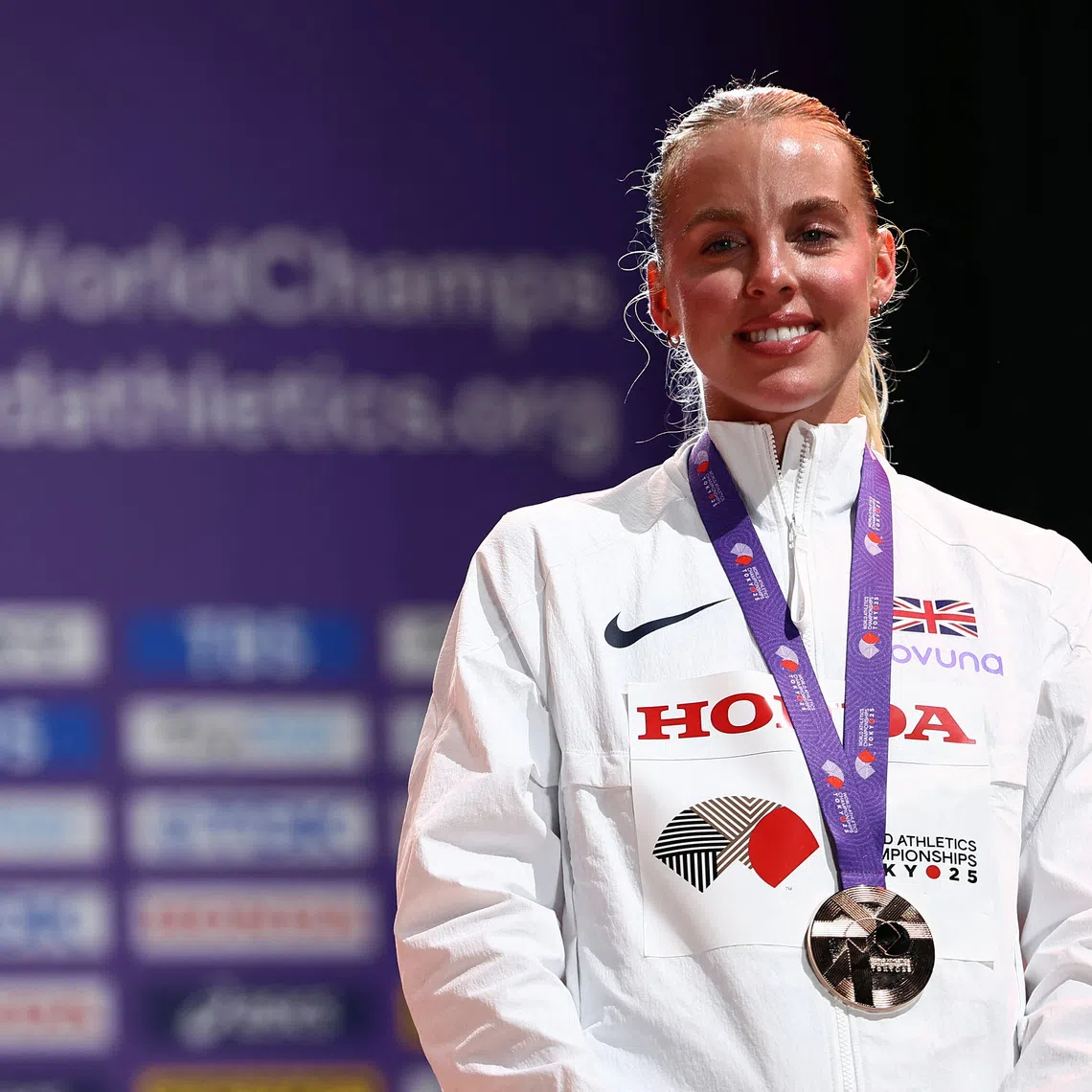 World Athletics Championships Tokyo 2025 - Women's 800m Medal Ceremony - Japan National Stadium, Tokyo, Japan - September 21, 2025 Bronze medallist, Britain's Keely Hodgkinson celebrates on the podium REUTERS/Eloisa Lopez