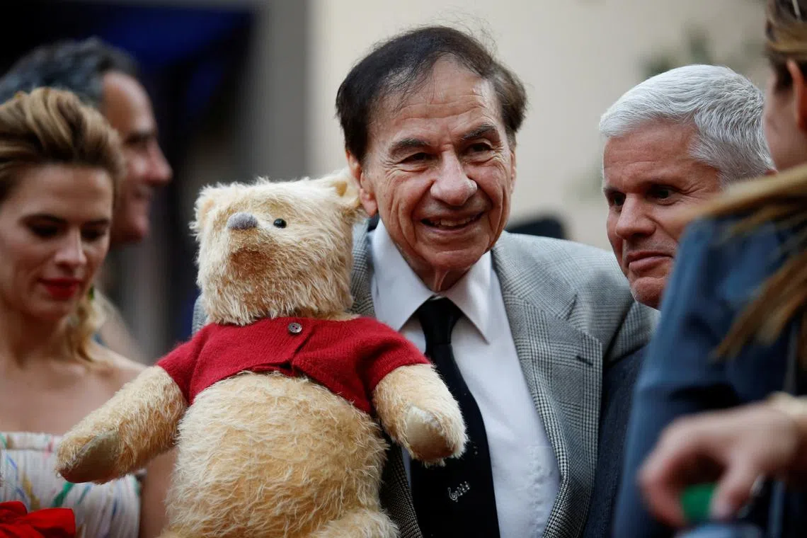 FILE PHOTO: Songwriter Richard M. Sherman holds a stuffed Winnie the Pooh as he poses at the world premiere of Disney's \"Christopher Robin,\" in Burbank, California, U.S., July 30, 2018. REUTERS/Danny Moloshok/File Photo