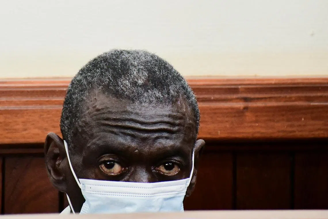 FILE PHOTO: Uganda's four-time presidential candidate Kizza Besigye sits in the dock where he was charged with treason alongside his colleague Obeid Lutale and Captain Denis Oola at the Chief Magistrate Court in Nakawa suburb of Kampala, Uganda, February 21, 2025. REUTERS/Abubaker Lubowa/File Photo
