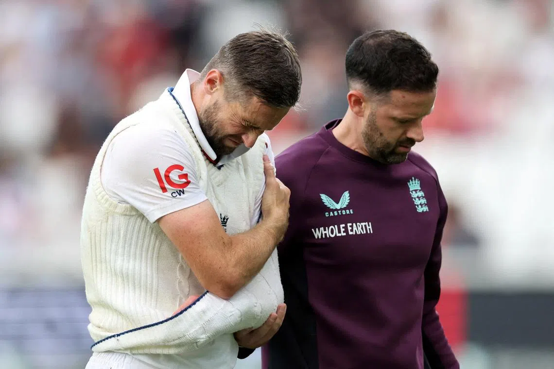 FILE PHOTO: Cricket - International Test Match Series - Fifth Test - England v India - Kia Oval, London, Britain - July 31, 2025 England's Chris Woakes reacts as he leaves the field after sustaining an injury Action Images via Reuters/Paul Childs/File Photo