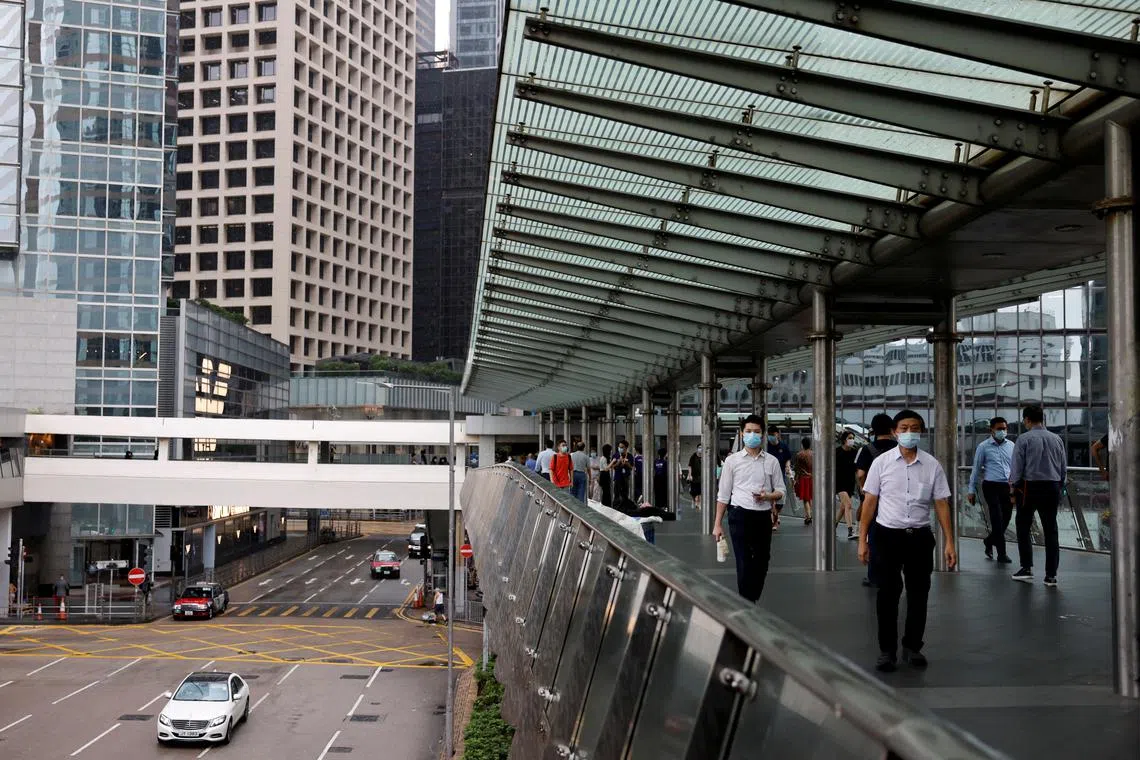 FILE PHOTO: People walk in the financial Central district following the COVID-19 outbreak in Hong Kong, China September 14, 2020. REUTERS/Tyrone Siu/File Photo