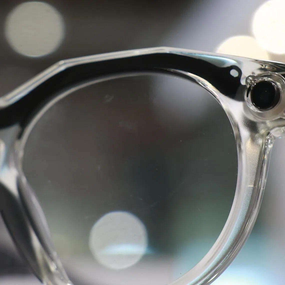 Close up of the camera installed in the frame of a pair of Meta AI glasses.