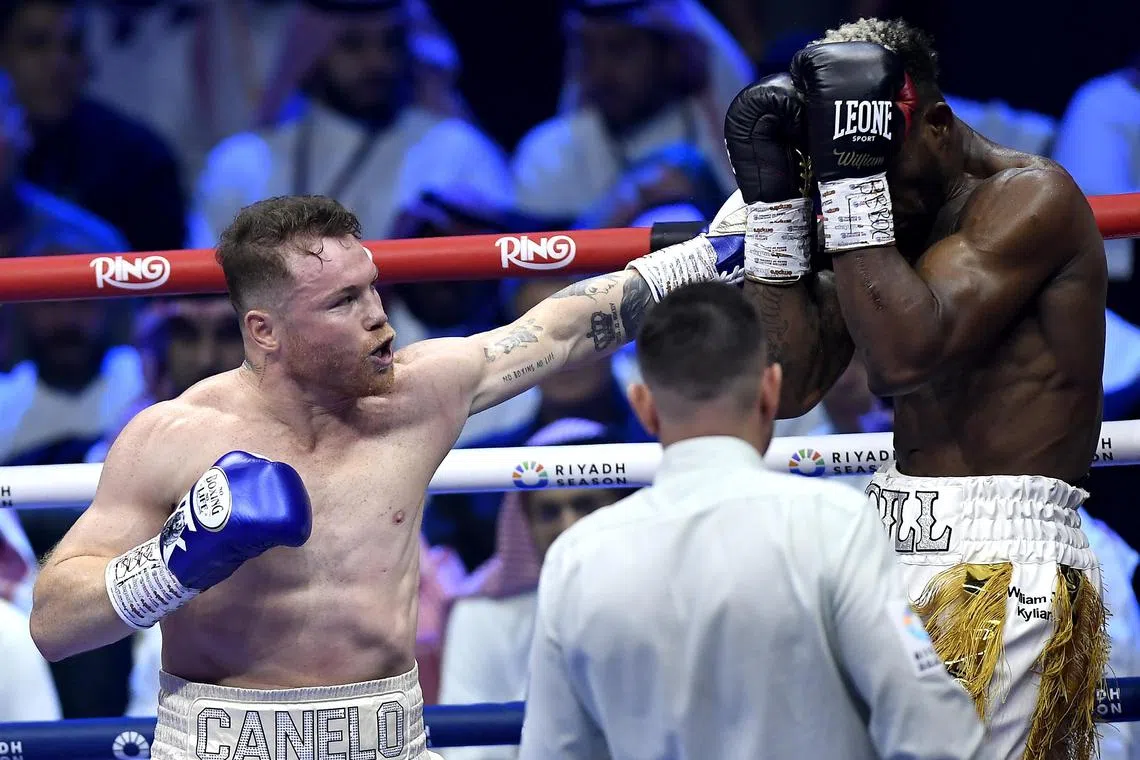 Saul "Canelo" Alvarez (left) of Mexico fighting William Scull in their IBF super middleweight title bout in Riyadh on May 4. The Mexican won to improve to 63-2-2, while the Cuban suffered his first loss (23-1). 