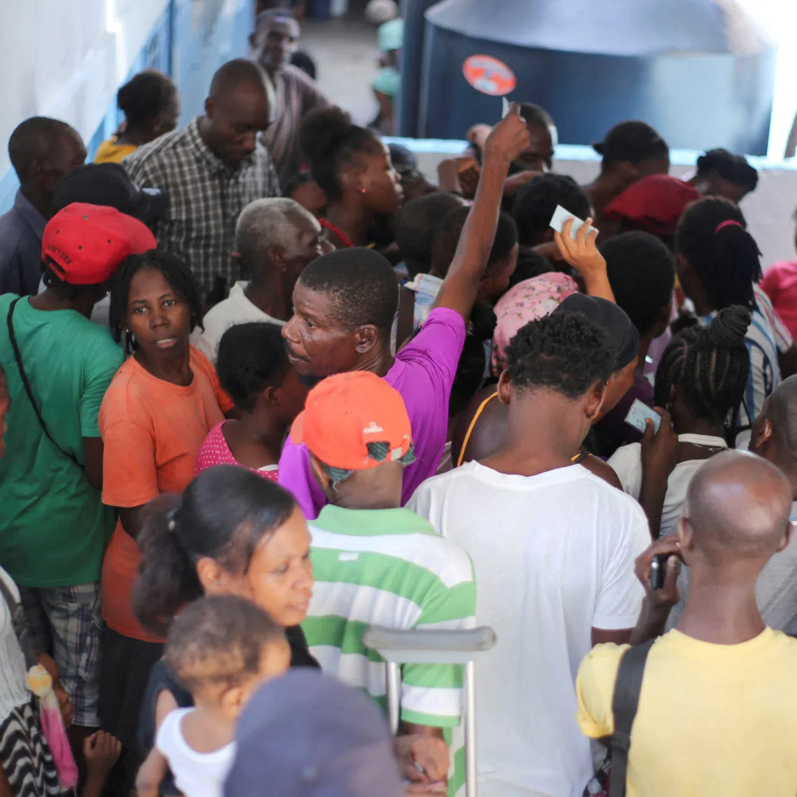 FILE PHOTO: People gather to receive food at the temporary shelter in College des Antilles as the country faces emergency food insecurity while immersed in a social and political crisis, in Port-au-Prince, Haiti October 4, 2024. REUTERS/Jean Feguens Regala/File Photo