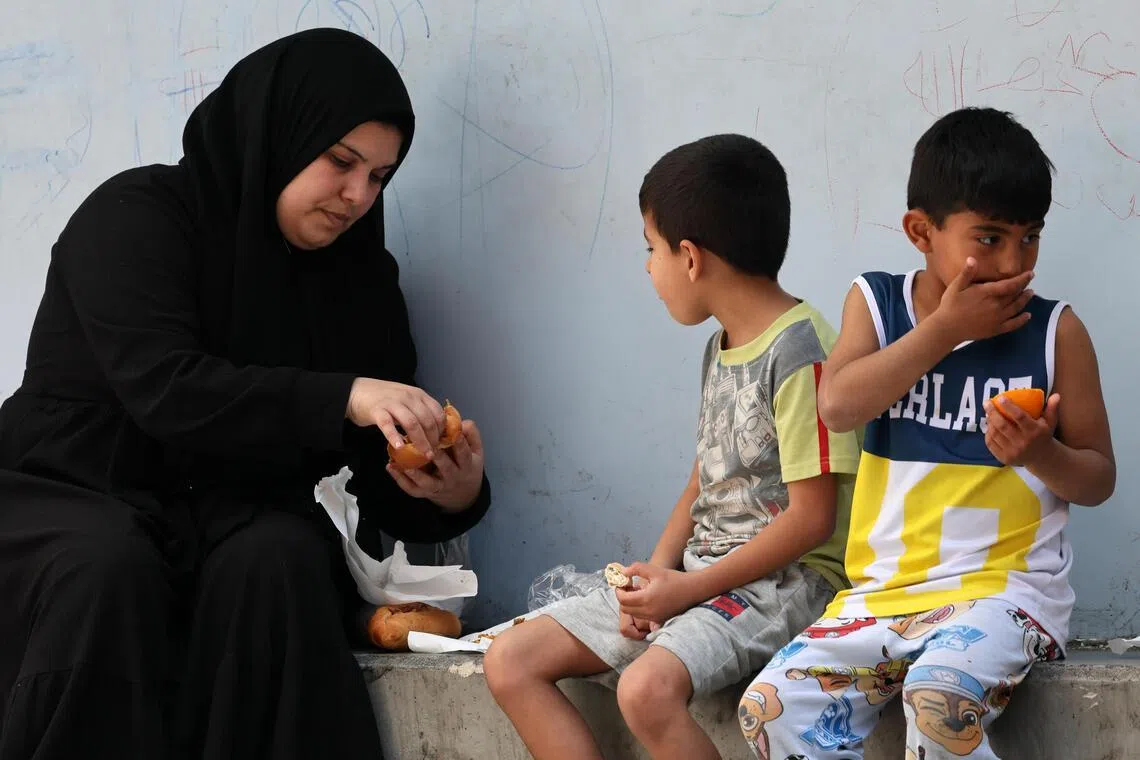 Displaced residents share a meal as they take shelter in a local school after fleeing their homes in southern Lebanon, following Israeli airstrikes, in Beirut, Lebanon, on April 29, 2026.