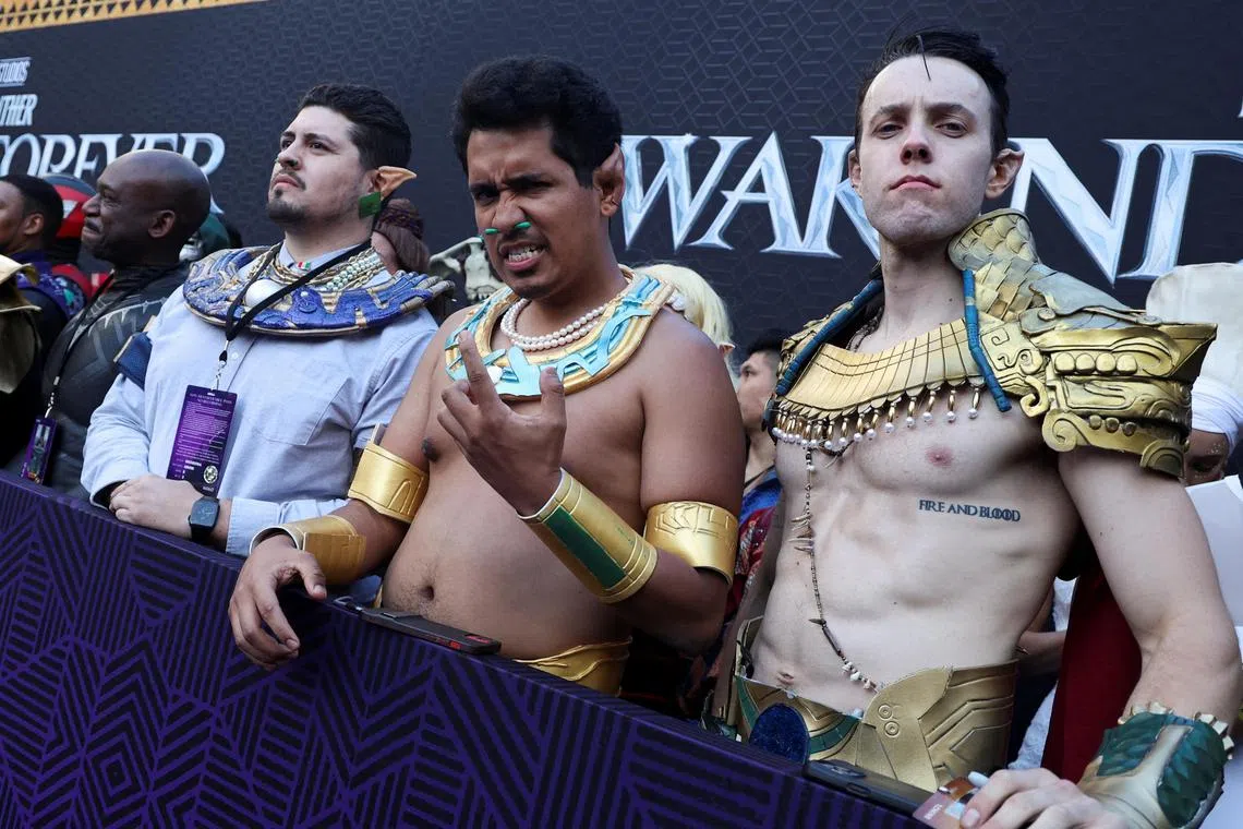 Fans in costumes stand at a premiere for the film Black Panther: Wakanda Forever in Los Angeles, California in October 2022.  