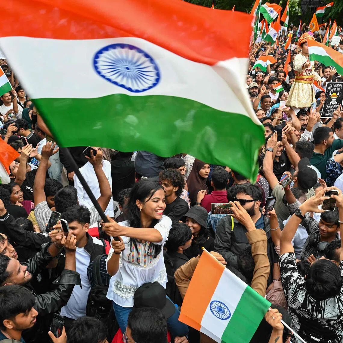 Cockroach Janta Party (CJP) supporters wave national flags a day after the resignation of India’s Education Minister Dharmendra Pradhan in Mumbai on July 26, 2026.