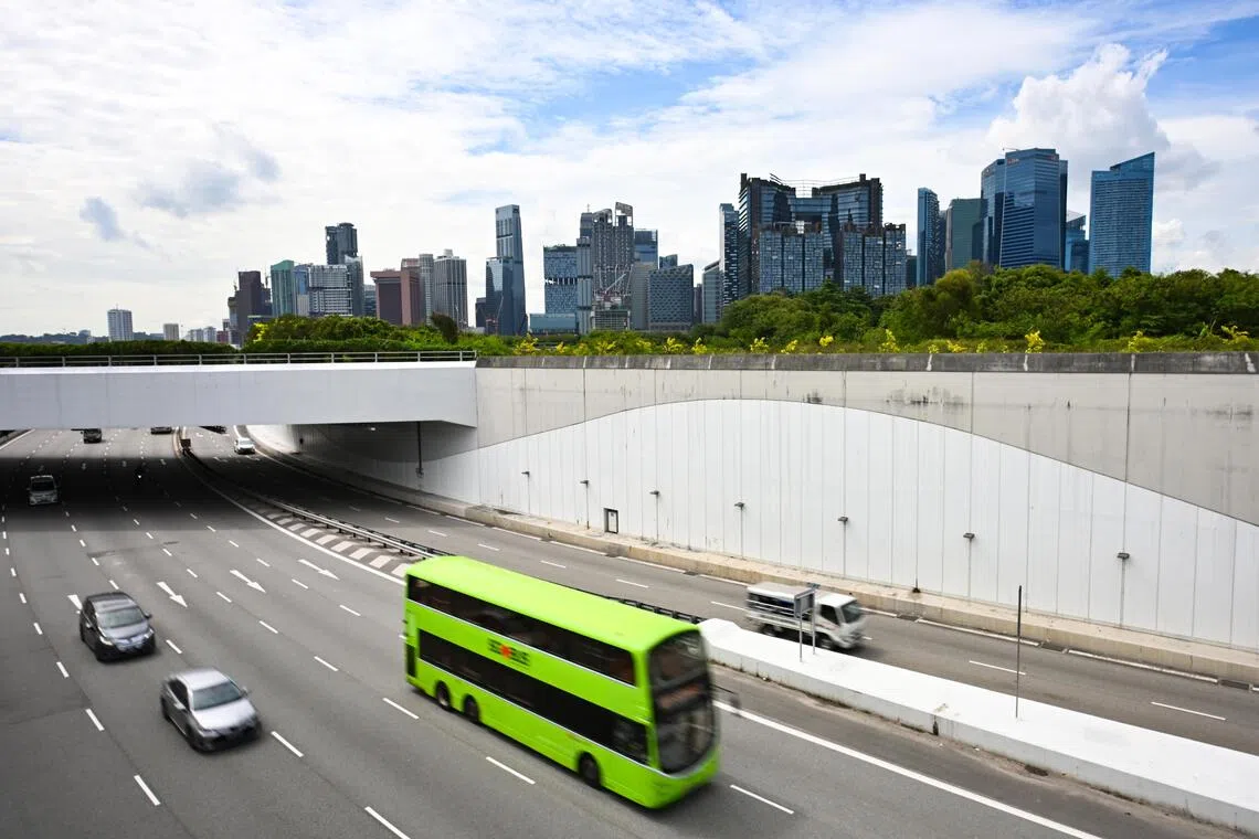 ST20251023-202588400444-Lim Yaohui-pixgeneric/ Generic photograph of vehicles travelling in the Marina Coastal Expressway (MCE) with buildings in the Marina Bay Financial Centre and Central Business District on Oct 23, 2025. Can be used for stories on transport, COE, car, bus, fare, money, population, property, land, commercial, office, invest, budget, income, bank, finance, financial, CBD, URA, population, economy, and development. (ST PHOTO: LIM YAOHUI)