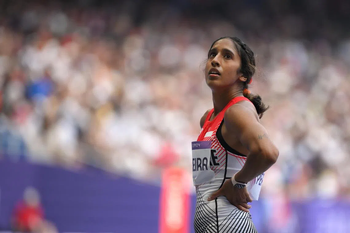Singapore sprinter Shanti Pereira (left) checks the scoreboard after the Paris 2024 Olympics Women's Athletics 100m round 1 at the Stade de France on August 2, 2024.