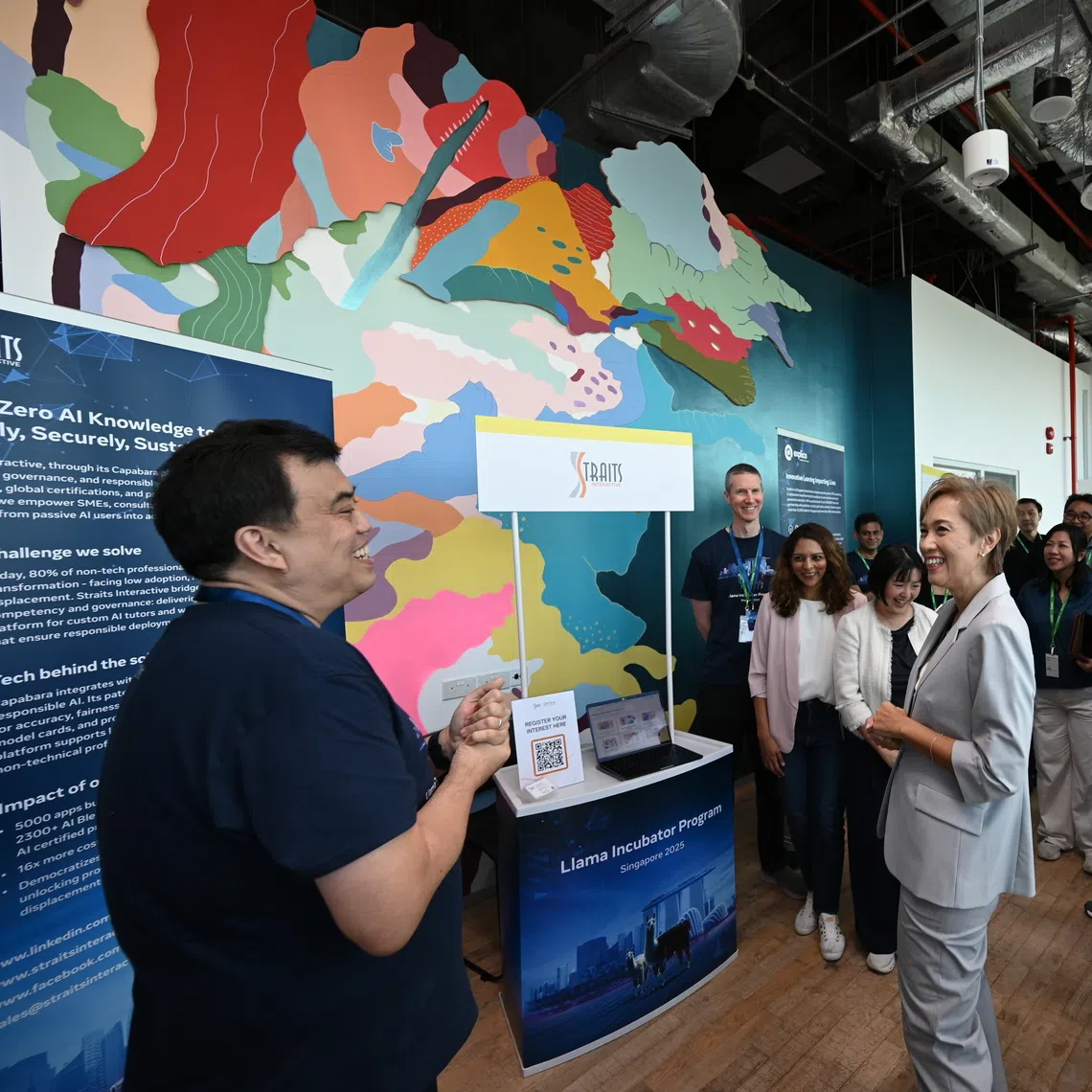 Digital Development and Information Minister Josephine Teo speaking to Straits Interactive's chief executive Kevin Shepherdson during the Meta Llama Incubator Program demonstration day on Oct 15.