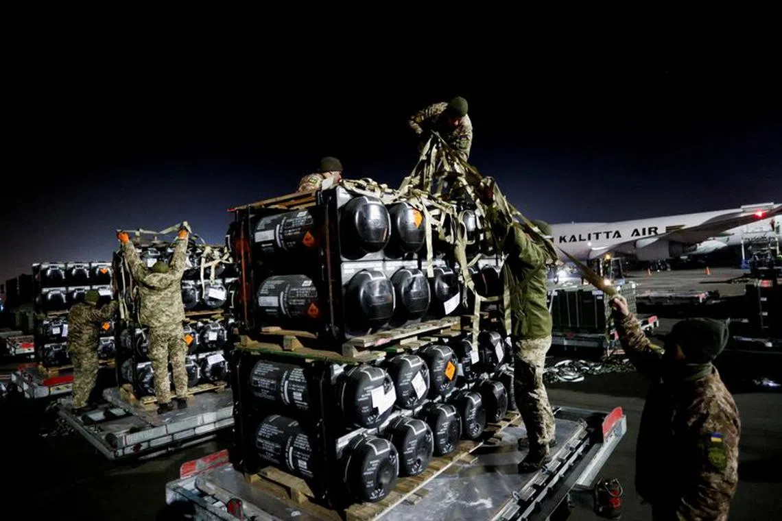 FILE PHOTO: Ukrainian service members unpack Javelin anti-tank missiles, delivered by plane as part of the U.S. military support package for Ukraine, at the Boryspil International Airport outside Kyiv, Ukraine February 10, 2022.  REUTERS/Valentyn Ogirenko/File Photo