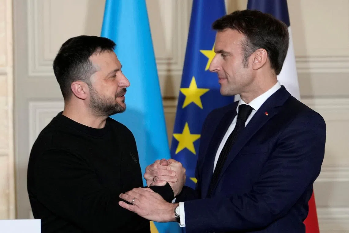 French President Emmanuel Macron and his Ukrainian counterpart Volodymyr Zelenskiy shake hands after a press conference, February 16, 2024 at the Elysee Palace in Paris, France.   Thibault Camus/Pool via REUTERS