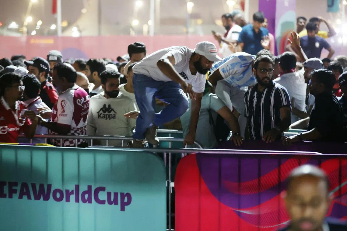 Fans jump over barriers at the fan festival held at Al Bidda Park, on Nov 20, 2022.
