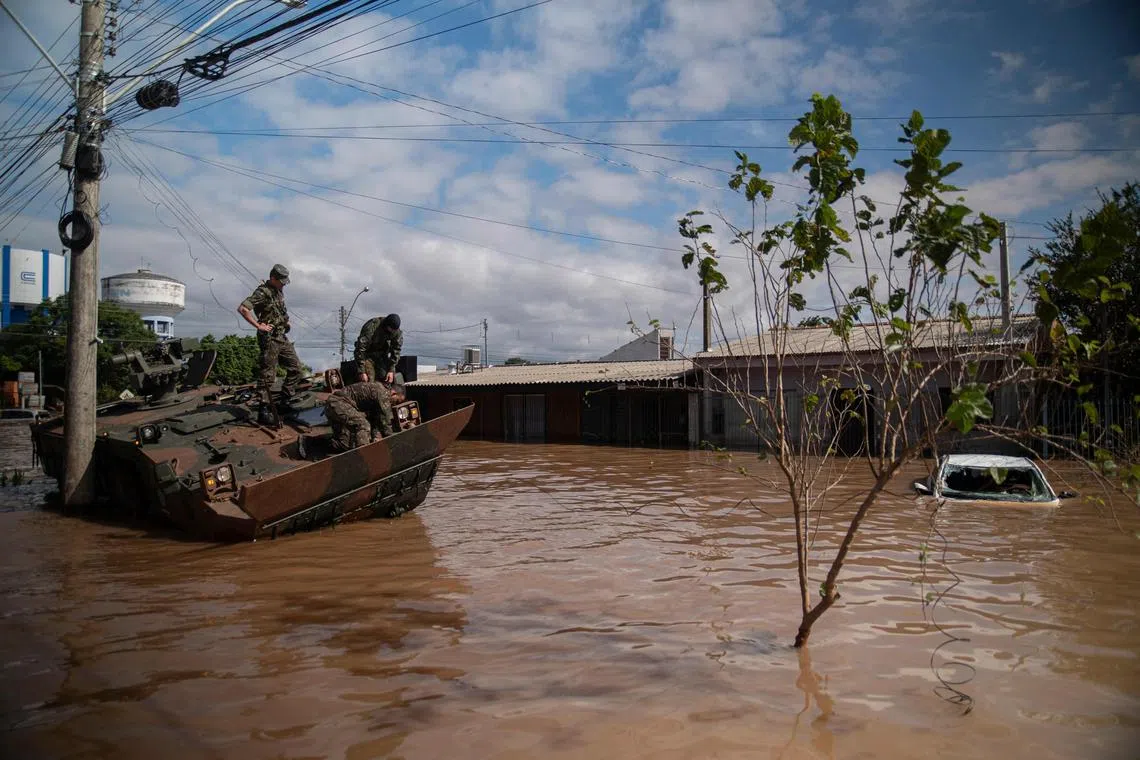 Army soldiers checking out their damaged vehicle at a flooded street in Eldorado do Sul, Rio Grande do Sul state, Brazil, on May 9.
