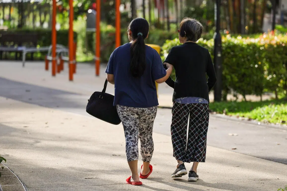 ST20240206_202448367874: Gin Tay/ pixgeneric/
Generic photo of an elderly woman accompanied by a helper near Toa Payoh Blk 142 on Feb 1, 2024.
Can use for stories on elderly, aging population, healthcare, foreign domestic helper, caregiver, seniors, reduce mobility, 