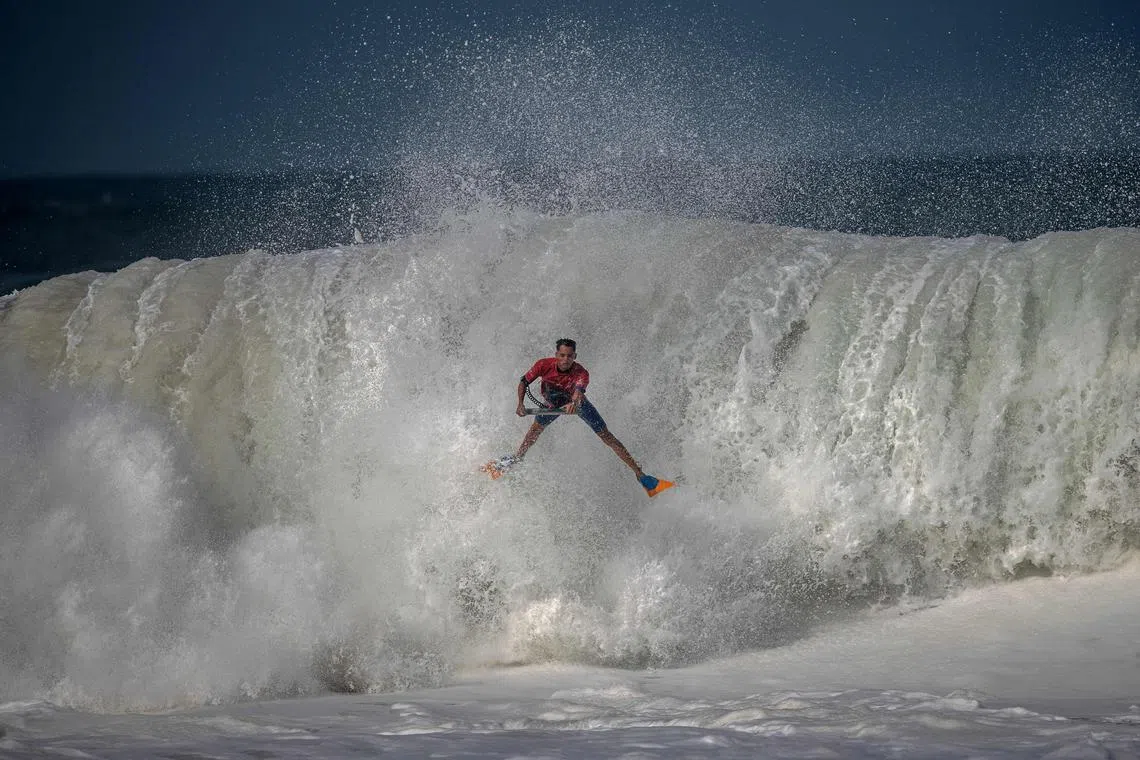 A surfer riding a wave on a bodyboard during the Itacoatiara Pro competition at Itacoatiara Beach in Rio de Janeiro, Brazil on June 15, 2023. 