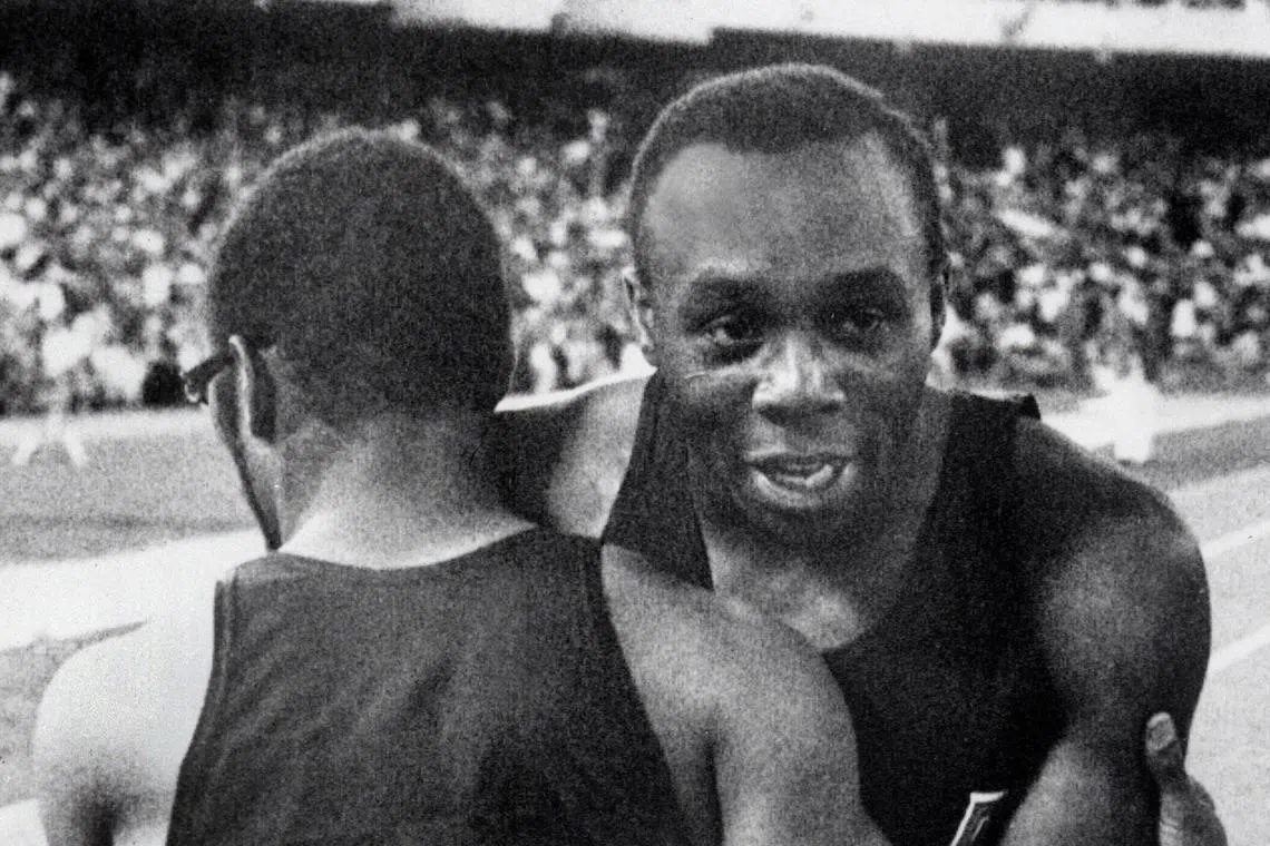 Jim Hines (right) congratulated by his compatriot Charles Green upon his Olympics 100m victory, in Mexico City, on Oct 14, 1968.