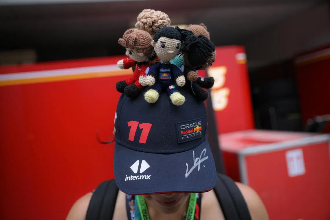 A fan sporting a handmade cap with knitted figures of various F1 race drivers seen at the F1 Paddock ahead of practice 3, of the Formula One Singapore Airlines Singapore Grand Prix, at the Marina Bay street circuit, on Sept 21, 2024.