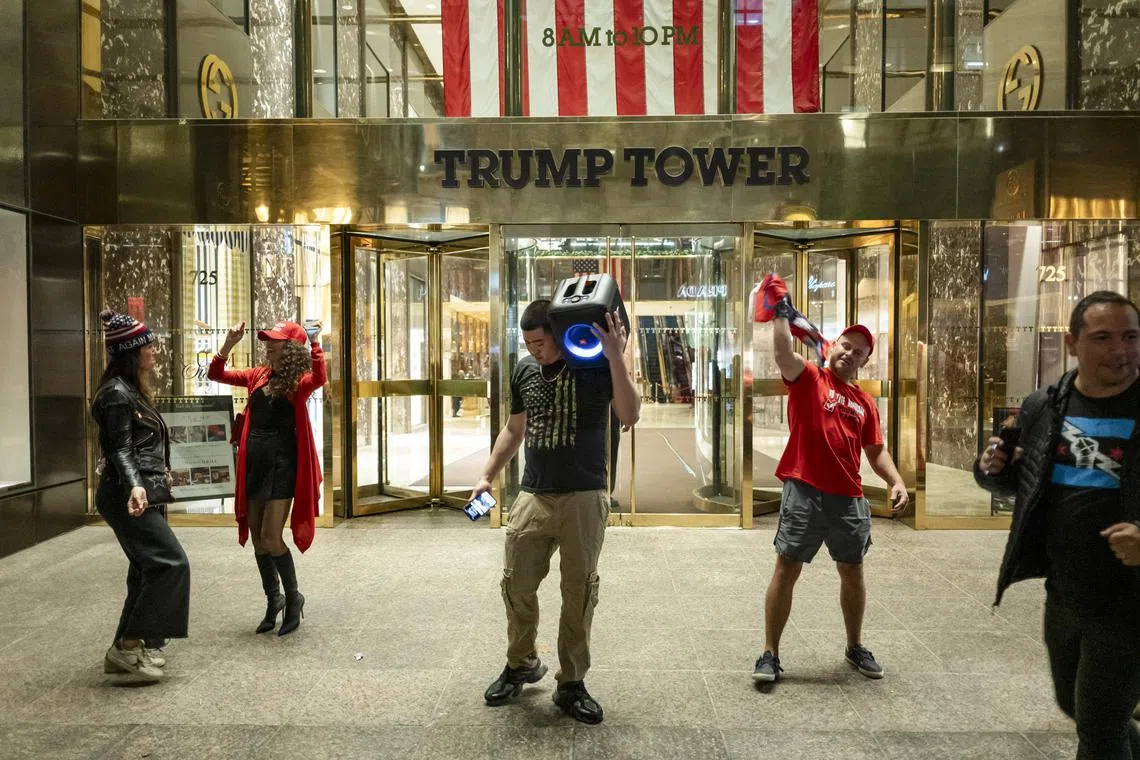 People dancing in front of Trump Tower on Election Day in New York, on Nov 5, 2024. 