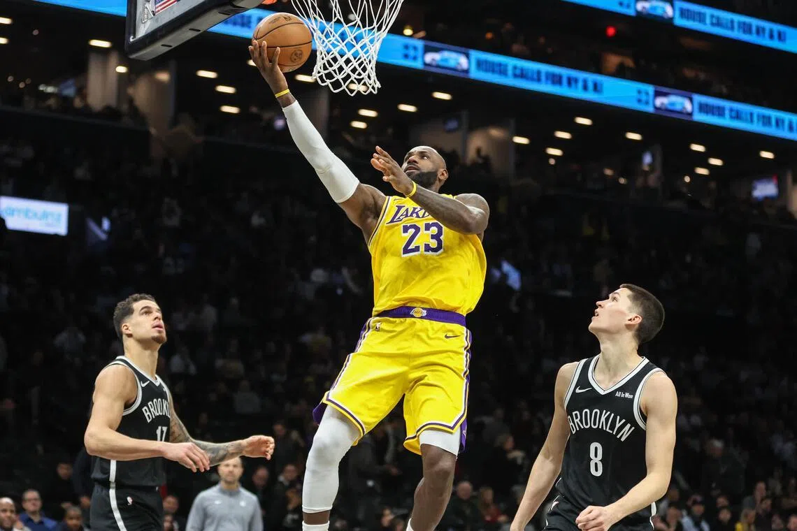 Los Angeles Lakers forward LeBron James drives past Brooklyn Nets guard Egor Demin in the third quarter at Barclays Center. 