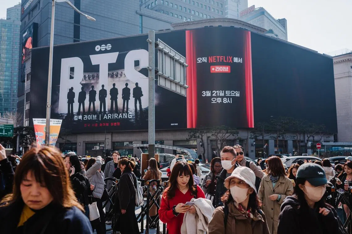 Fans disperse after the media show featuring BTS at Shinsegae Square in Seoul, South Korea, Mar. 21, 2026. The group performed their first concert in three years, five months and six days, as obsessive fans point out. (Jun Michael Park/The New York Times)