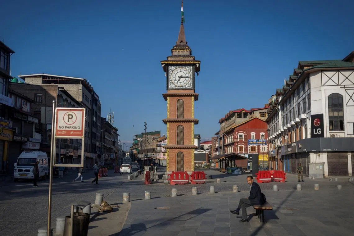 A Kashmiri man sits on a bench in front of a clock tower, at Lal Chowk area in Srinagar, Kashmir, April 29, 2025. REUTERS/Adnan Abidi