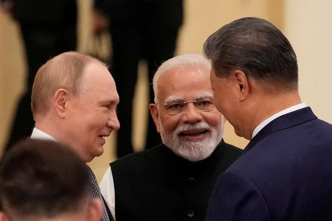 FILE PHOTO: Indian Prime Minister Narendra Modi talks with Russian President Vladimir Putin and Chinese President Xi Jinping ahead of the Shanghai Cooperation Organization (SCO) Summit 2025 at the Meijiang Convention and Exhibition Centre in Tianjin, China, September 1, 2025.  SUO TAKEKUMA/Pool via REUTERS/File Photo