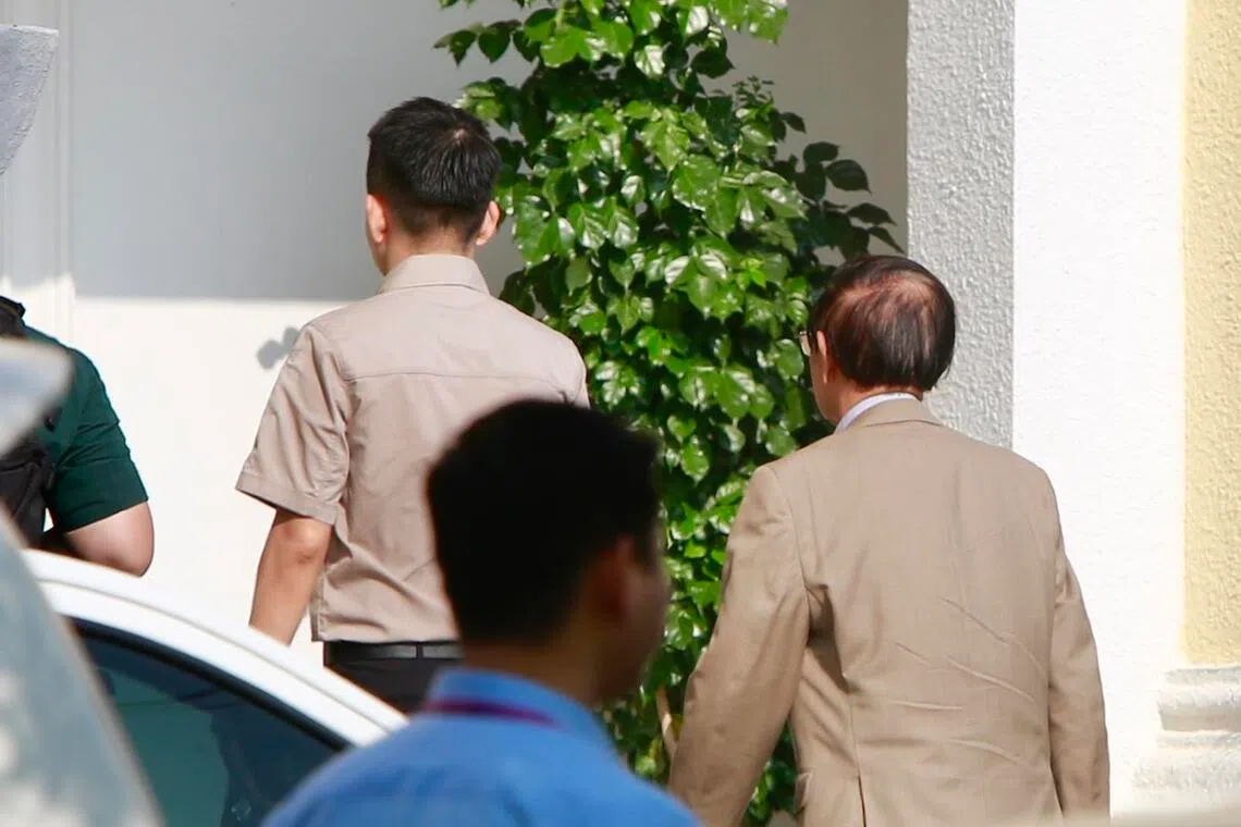 Detained Cambodian opposition leader Kem Sokha (right) attends a hearing at the Municipal Court in Phnom Penh, Cambodia, on April 8.