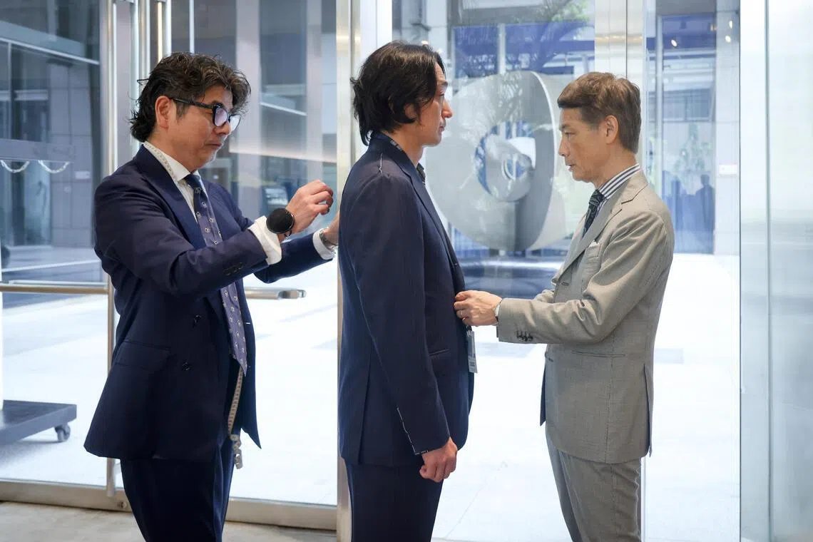 Beams creative director Tatsuya Nakamura (right) and expert fitter Tamao Shirai (left) demonstrating a suit fitting at Colony Clothing.
